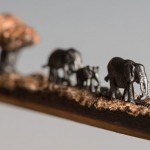 Artista usa lápis para esculpir, em detalhes, elefantes caminhando